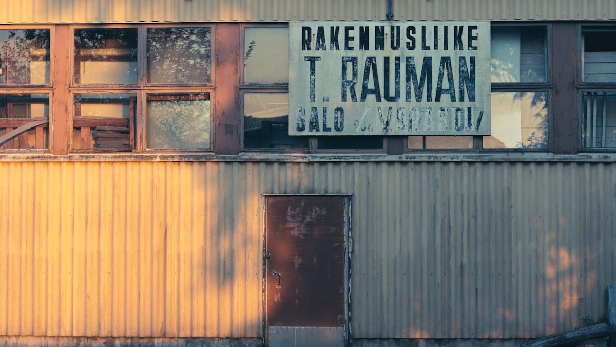An old building with a sign in a foreign language.